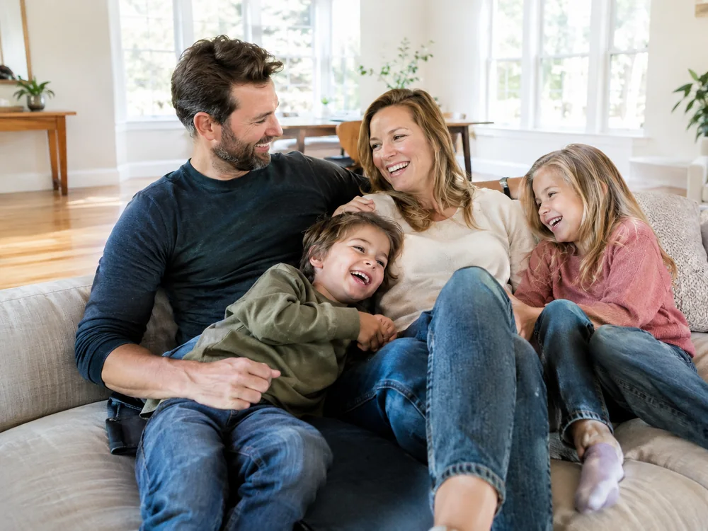A happy Utah family relaxing at home with more space after GoHaulStrong junk removal